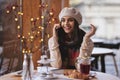 Attractive young woman having a call while sitting at the cafe Royalty Free Stock Photo