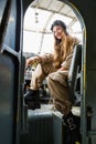 Attractive young woman in a helmet and pilot`s suit sits in the cockpit