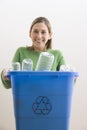 Attractive Young Woman Holding a Blue Recycle Bin