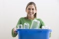 Attractive Young Woman Holding a Blue Recycle Bin