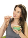 Attractive Young Woman Holding a Bowl of Salted Peanuts