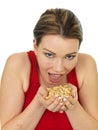 Attractive Young Woman Holding A Handful of Salted Roasted Peanu