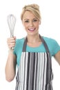 Attractive Young Woman Holding a kitchen Whisk Royalty Free Stock Photo