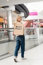 attractive young woman holding paper bag with lettering black friday and looking at camera at shopping Royalty Free Stock Photo