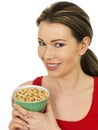 Attractive Young Woman Holding Salted Roasted Peanuts