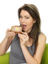 Attractive Young Woman Holding a Slice of Gala Pie Royalty Free Stock Photo