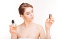 Attractive young woman holding two bottles of parfums Royalty Free Stock Photo