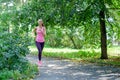 Attractive young woman jogging on park trail. healthy lifestyle concept Royalty Free Stock Photo