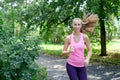 Attractive young woman jogging on park trail. healthy lifestyle concept Royalty Free Stock Photo