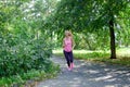 Attractive young woman jogging on park trail. healthy lifestyle concept Royalty Free Stock Photo