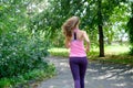Attractive young woman jogging on park trail. healthy lifestyle concept Royalty Free Stock Photo