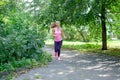 Attractive young woman jogging on park trail. healthy lifestyle concept Royalty Free Stock Photo