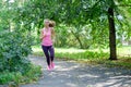 Attractive young woman jogging on park trail. healthy lifestyle concept Royalty Free Stock Photo