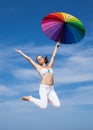 Attractive young woman jumping with parasol Royalty Free Stock Photo