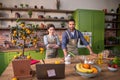 Attractive young woman in the kitchen together with her partner Afro American man looking something on the laptop then Royalty Free Stock Photo