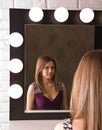 An attractive young woman looking in the mirror Royalty Free Stock Photo