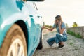Attractive young woman looking sad, calling car service, assistance or tow truck while having troubles with her auto Royalty Free Stock Photo