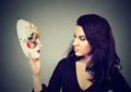 Attractive woman looking at traditional carnival mask