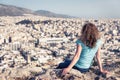 Attractive young woman looks at cityscape Athens, Greece Royalty Free Stock Photo