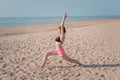 Attractive young woman making yoga on the beach Royalty Free Stock Photo