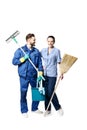 An attractive young woman and man in cleaning uniform and rubber gloves holding a broom cleaning products in his hands, isolated Royalty Free Stock Photo