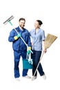 Attractive young woman and man in cleaning uniform and rubber gloves holding a broom cleaning products in his hands, isolated on Royalty Free Stock Photo