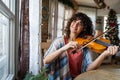 Attractive young woman musician plays the violin practicing musical instrument Royalty Free Stock Photo