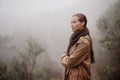 Musings in the mist. An attractive young woman out for a walk in the mountains.