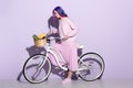 attractive young woman in pink clothing on bicycle with pineapple and bananas Royalty Free Stock Photo