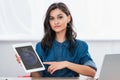 attractive young woman pointing on ipad tablet