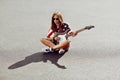 Attractive young woman posing with guitar Royalty Free Stock Photo