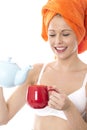 Attractive Young Woman Pouring Tea from a Teapot Royalty Free Stock Photo