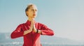 Attractive Young Woman Prays And Practicing Yoga On The Beach. Healthy Lifestyle Biohacking Fitness Concept