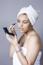 Attractive young woman putting on makeup Royalty Free Stock Photo