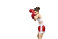 Attractive young woman in red boxing gloves and shorts stand in a boxing stance and protect her head, isolated on white. Royalty Free Stock Photo