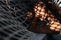 Attractive young woman is relaxing outdoor while lying in hammock. Royalty Free Stock Photo