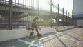 Attractive young woman with roller skating on the street, having fun timen at sunset