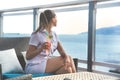 Woman sits in the beach bar with coctail