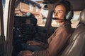 Attractive young woman sitting inside plane cockpit Royalty Free Stock Photo