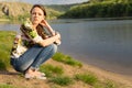 Attractive young woman sitting beside a lake Royalty Free Stock Photo