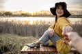 Stylish girl in a hat enjoying the sunset on a date Royalty Free Stock Photo