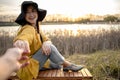 Stylish girl in a hat enjoying the sunset on a date Royalty Free Stock Photo