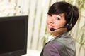 Attractive Young Woman Smiles Wearing Headset Royalty Free Stock Photo