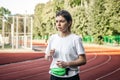 Attractive young woman in sportswear jogging at the stadium. Royalty Free Stock Photo