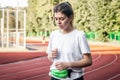 Attractive young woman in sportswear jogging at the stadium. Royalty Free Stock Photo