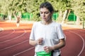 Attractive young woman in sportswear jogging at the stadium. Royalty Free Stock Photo