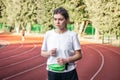 Attractive young woman in sportswear jogging at the stadium. Royalty Free Stock Photo