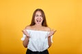 Attractive young woman spreads hands, screaming isolated on orange wall Royalty Free Stock Photo