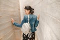 Attractive young woman standing between concrete walls. Caucasian girl in casual jeans and dress Royalty Free Stock Photo