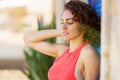 Attractive young woman standing near blue shutters Royalty Free Stock Photo